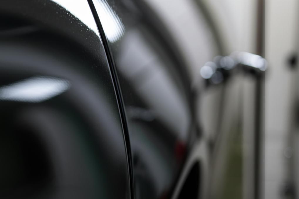 Close-up view of a car panel with a perfectly applied clear film