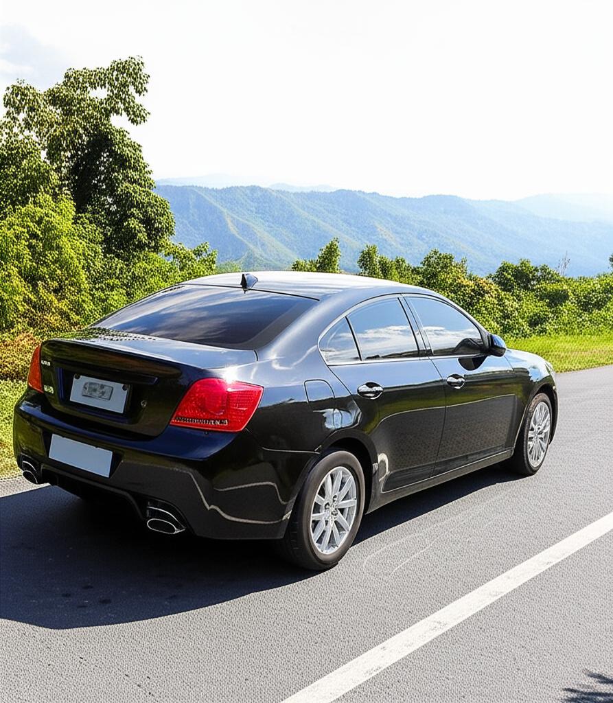 Shiny car protected by PPF driving on a scenic mountain road in Thailand.