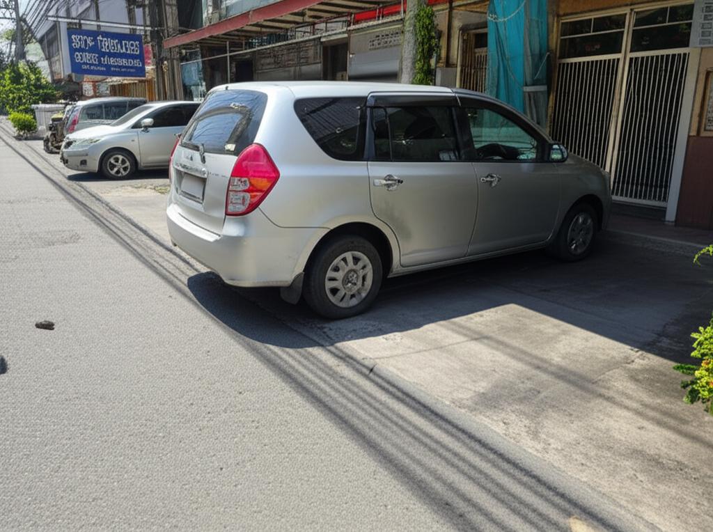 Family car parked in a sunny Thai street, looking vulnerable to the elements.
